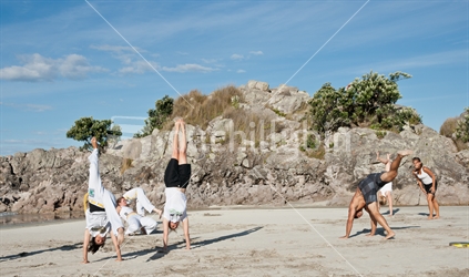 Capoeira Tauranga, members practicing on Mount Maunganui beach on Monday 23 January 2012.
Capoeira is considered an art, a sport and a philosophy by it's followers. It was founded in Brazil in 1984.