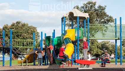 Colourful playground, children playing on the eqipment in Tauranga's Memorial Park.