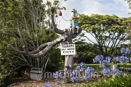 Humorous sign and garden sculpture "tsunami warning"