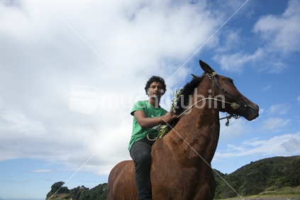 Horse and rider on Te Kaha beach.