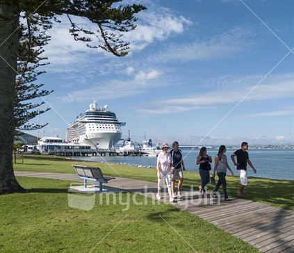 Cruise Ship berthed at Mount Maunganui, and disembarked passengers walking along the bay boardwalk,  Bay of Plenty, New Zealand.