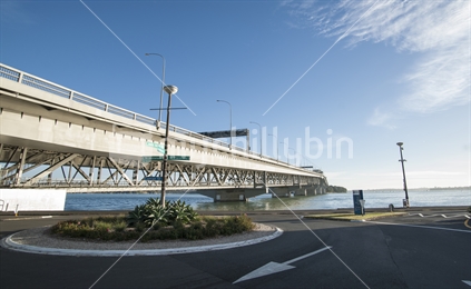 Auckland Harbour Bridge  stretching to the horizon from the Westhaven roundabout after sunrise in March 2014.