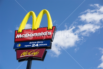 McDonalds fast food signage with the traditional golden arches, 24 hour service and Mc Cafe in February 2015.