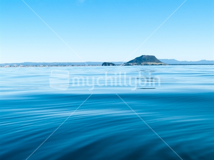 Ocean blue Mount Maunganui on horizon and Kaimai Range behind.