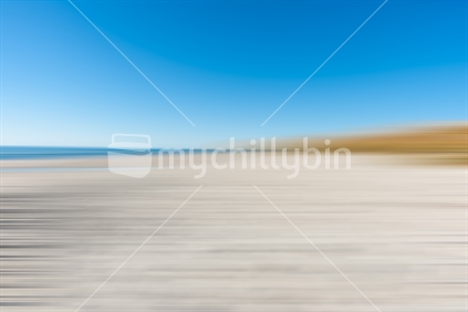 Papamoa abstract on crisp clear winter day, blue sea and sky to horizon over sand  and beach.