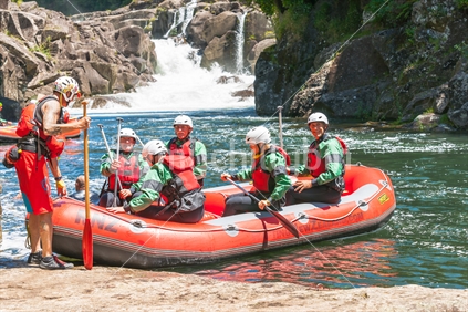 Group of enthusiasts under supervision of their guide commencing Wairoa River Rafting Tauranga, December 2016 on one of New Zealand's most popular rivers for kayaking and rafting