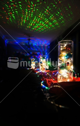 Christmas lights decorations in dark interior on Christmas eve with strobe lights and dark background with copy space