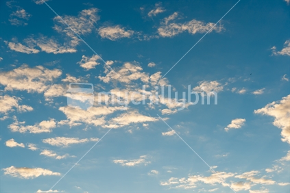 Blue sky and cumulus cloud formation reflected in calm water