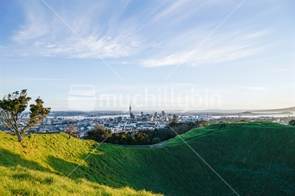 Shadow in crater Mount Eden with Auckland Harbour and skyline with Sky Tower landmark
