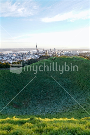 Shadow in crater Mount Eden with Auckland Harbour and skyline with Sky Tower landmark