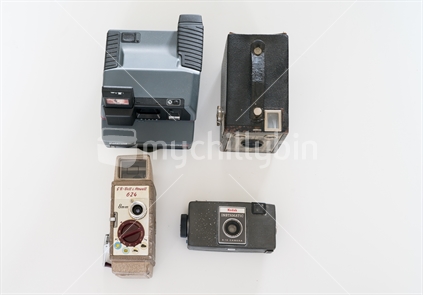 Four old out of date cameras arranged in flat design on white