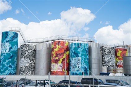 Auckland tanks painted with quotes on patterned backgrounds.