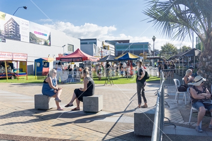 TAURANGA NEW ZEALAND - APRIL 1, 2018; People enjoying busy summer day  downtown in Masonic Square on Strand