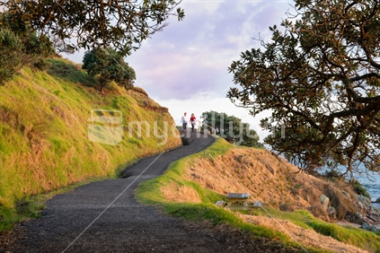 Two women on early morning walk around base track around from Mount Maunganui.