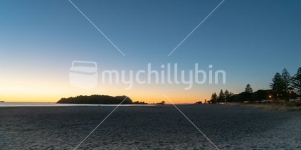 Mount Maunganui ocean beach amd Moturiki Island at sunrise, Tauranga, New Zealand.