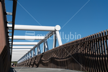 TAURANGA, NEW ZEALAND - AUGUST 12 2018; Wavy pattern of architectural timber sides of white steel Takatimu Drive Overbridge i- an elevated pedestrial and cycle bridge crossing the highway below
