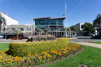TAURANGA NEW ZEALAND - SEPTEMBER 20 2018; Tauranga New and Old.  Floral Steamer garden constructed in 1938 has graced The Strand in Tauranga ever since - with an old and one of newest buildings in background.