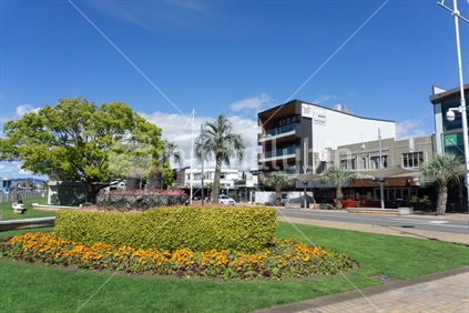 TAURANGA NEW ZEALAND - SEPTEMBER 20 2018; Tauranga new and old - Floral Steamer garden constructed in 1938 has graced The Strand in Tauranga ever since with old and one of newest buildings in background