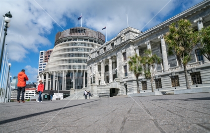 WELLINGTON, NEW ZEALAND - OCTOBER 2 2018; Tourists taking photographs , talikng and walking by on paved forecourt  outside Parliament building and Beehive