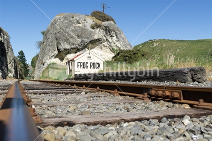 Railway lines through gorge, between large rock outcrops past old disused Frog Rock Station in Waipara Valley north Canterbury New Zealand.