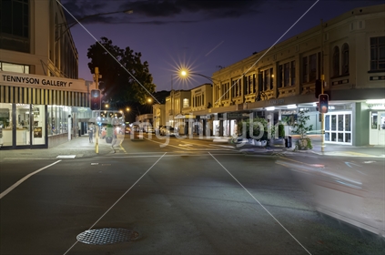Napier - New Zealand - February 16 2020; Tennyson Street intersection long exposure image at night with passing vehicles blurred.