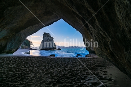 Scenic view through natural arch of Cathedral Cove on Coromandel peninsula New Zealand.