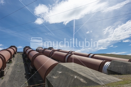 Four large pipes or penstocks sullpying water by gravity to electric power station at Ohau B station.