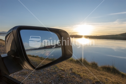 Beautiful landscape view in rear vision mirror Ohau Canal and surrounding land and hills.