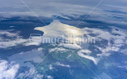 Aerial through scattered cloud with view to coastline of  Southland  lamdscape