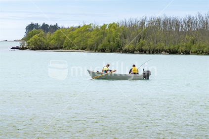 Canterbury New Zealand - November 20 2020;Two men in small boat in river fishing.