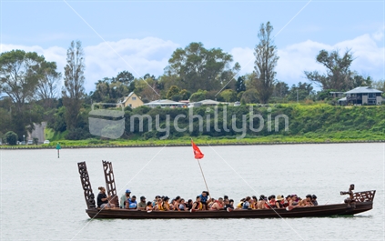 Tauranga New Zealand March 25 2023; Maori long canoe filled with paddlers on harbour