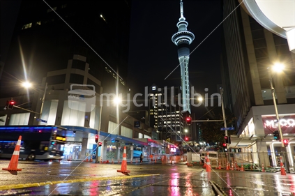 Auckland New Zealand - Julky 1 2023; Rainy night and wet city street in darkness of morning before city come to life on intersection where City Rail Link road construction is happening.