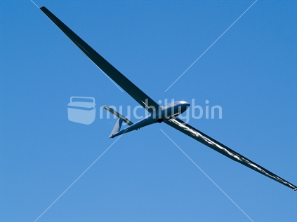 Glider, viewed from below against clear blue sky