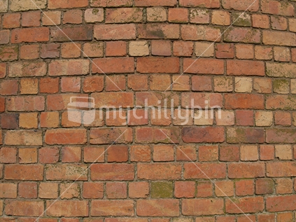 Brick background section of the curved wall of old brick water tower