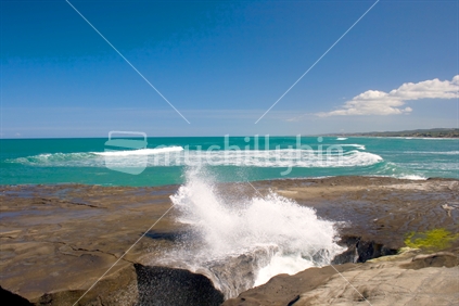 Waves crashing into rocks at Muriwai
