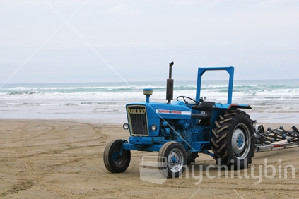 Tractor waiting on beach for fishing boat to return