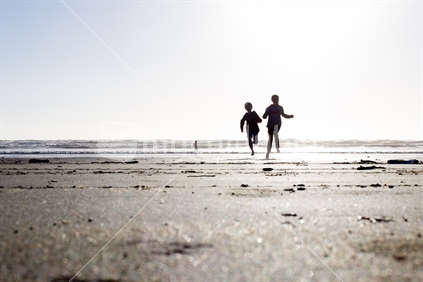 Children running on the beach Limited depth of field