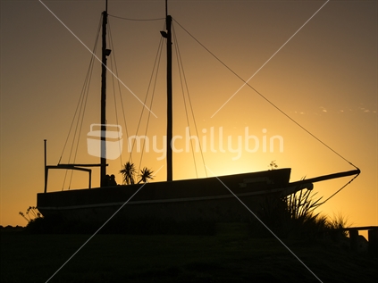 Old sailing vessel in sunset at Hokitika.