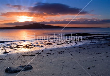 Sunrise on Auckland's North Shore with a view of Rangitoto Island 