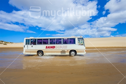 Tourist Coach driving at the end of 90 Mile Beach