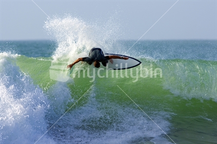 Guy hitting the lip on his surfboard