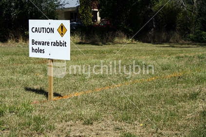 Event Caution sign, Gibbston Valley. Beware of rabbit holes, a common and dangerous occurrence in the land in Central Otago.