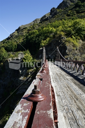 Large bolts, wire rope and wooden planks of the Historic Kawarau Bridge, Central Otago.