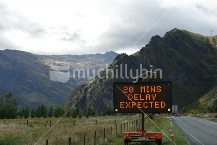 20 min delay sign, while Nevis Bluff is blasted to remove loose rocks for safety.  Central Otago.
