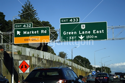 Overhead signs and vehicles on Auckland City motorway.