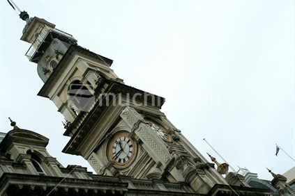 An angled image of the clock tower on an historic building in the Octagon, Dunedin, New Zealand