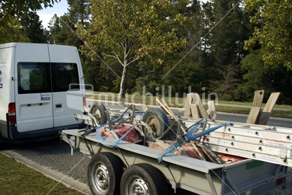 Builder's tools and equipment loaded on a trailer for transporting.