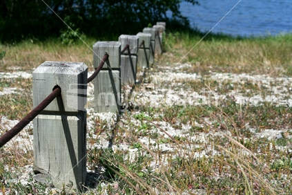 A square wooden and wire safety barrier securing a carpark area by Lake Dunstan in Cromwell. New Zealand