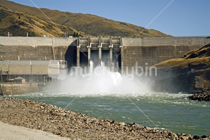 Clyde Dam with flood gates open, releasing water from Lake Dunstan.