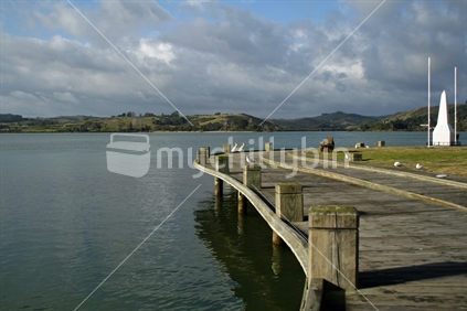 A manmade wooden boardwalk around the edge of Mangonui Harbour, Northland.